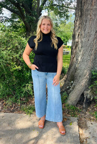 Solid short sleeve mock neck top featuring pleated waist shaping