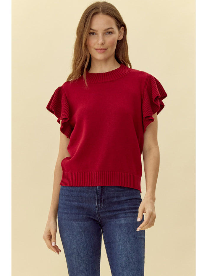 Solid knit top with a crew neck ruffled shoulde