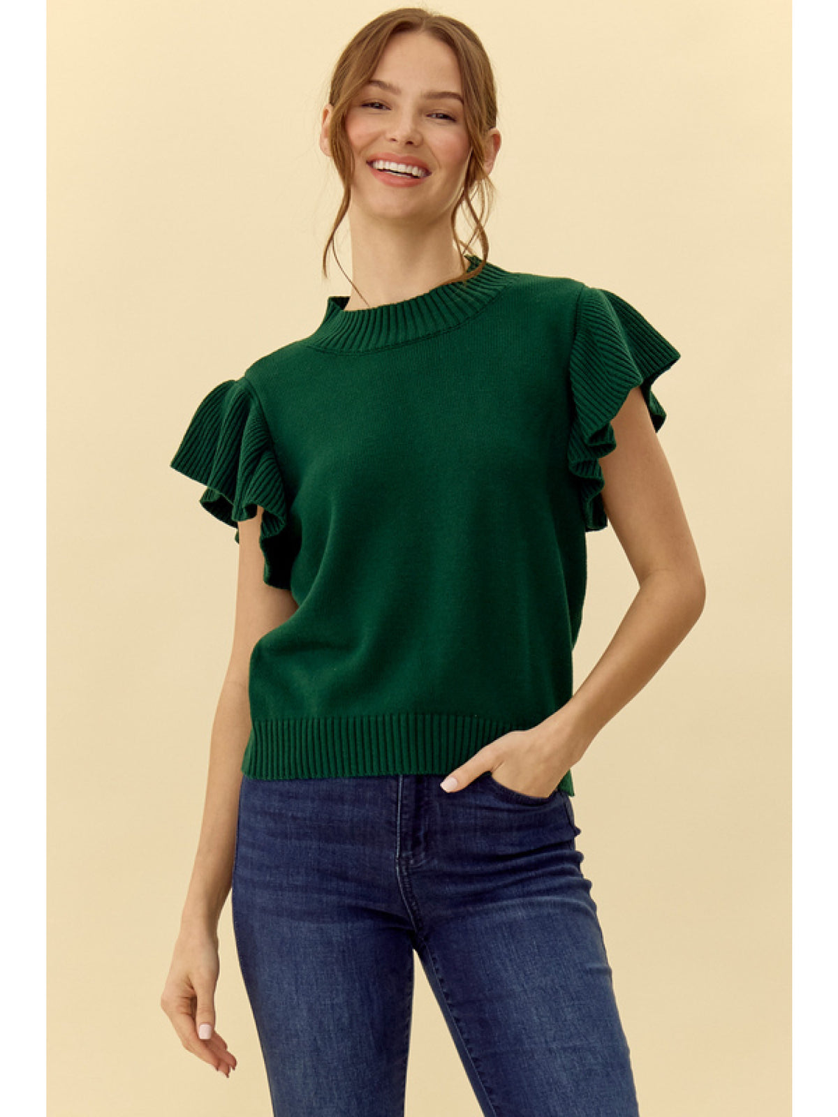 Solid knit top with a crew neck ruffled shoulde