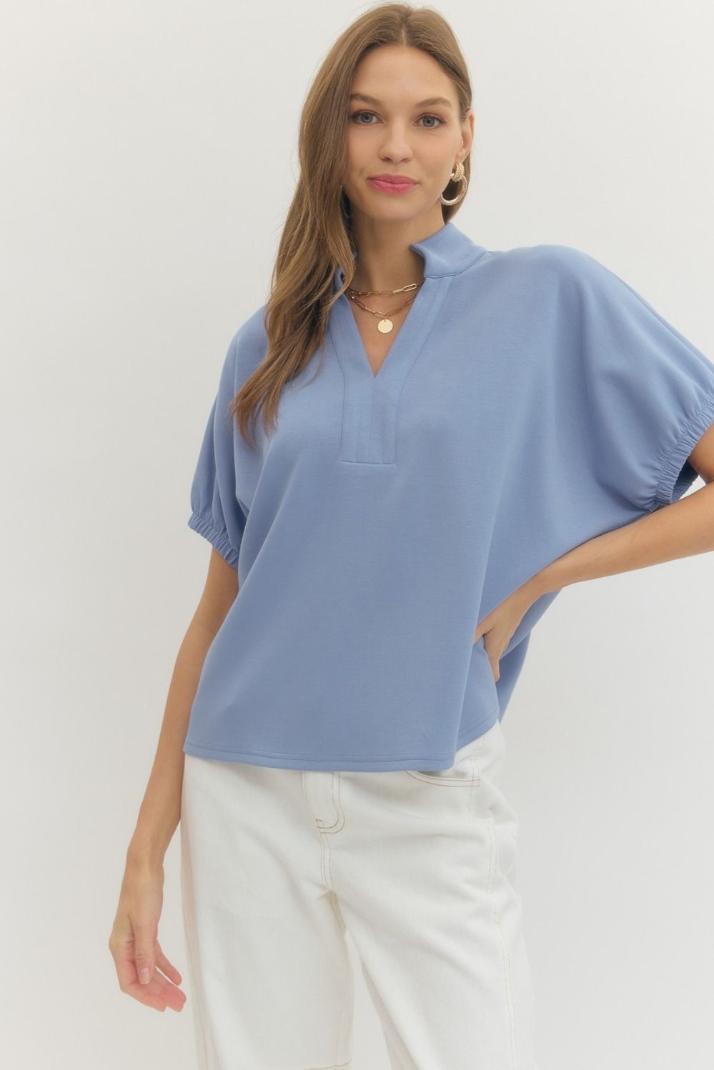 Solid short sleeve top featuring split V-neck with collar band
