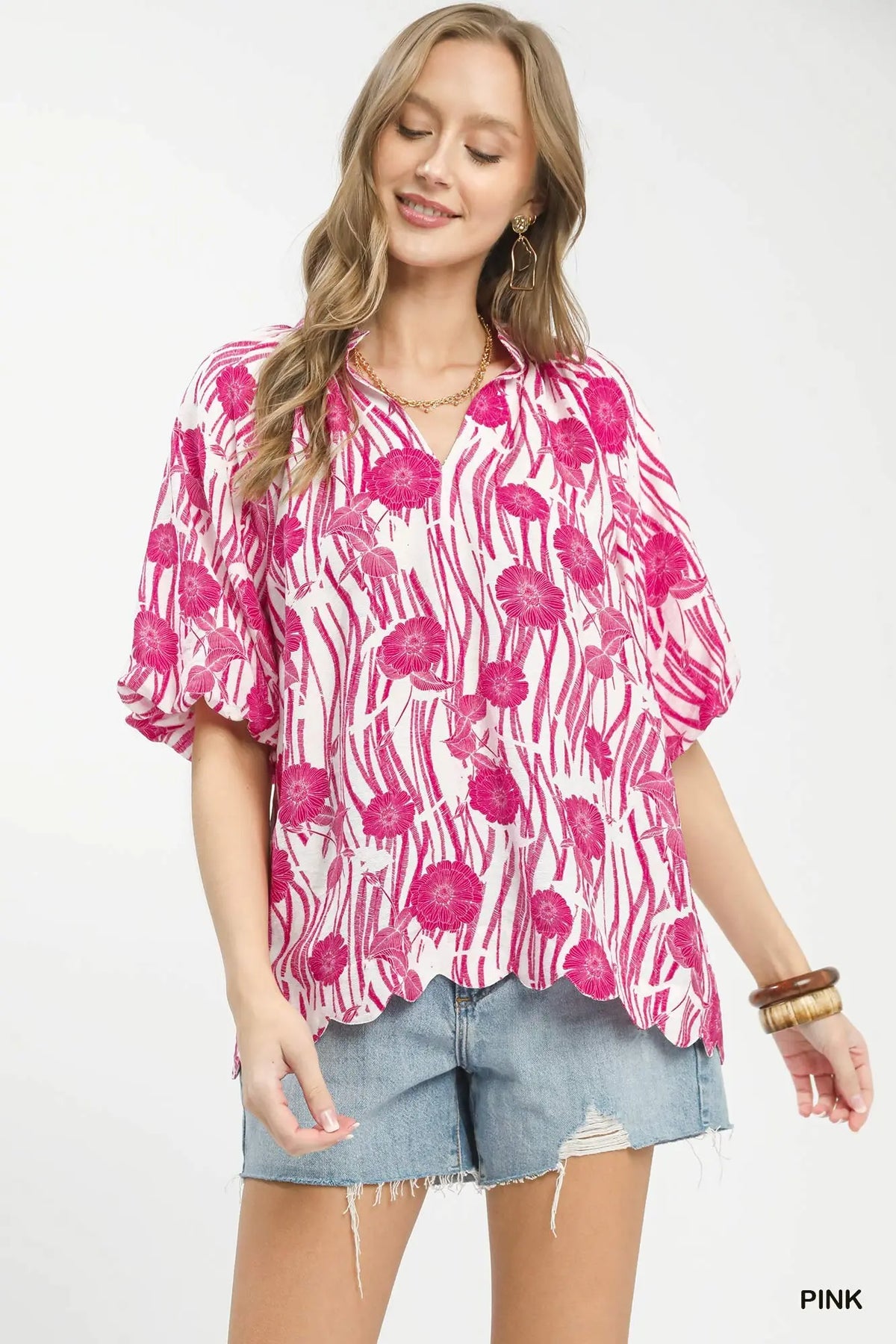 Floral Print Top Oversized silhouette with gathered neckline delivers fresh, artistic appeal with graphic impact.