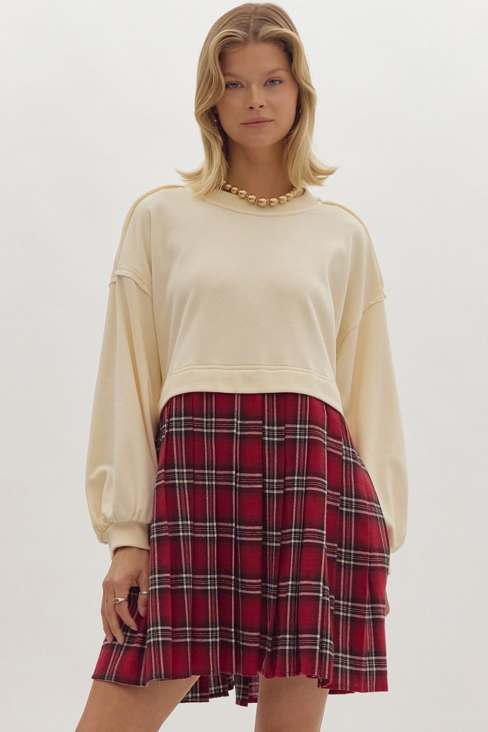 Twofer solid long sleeve mini dres featuring plaid skirt.