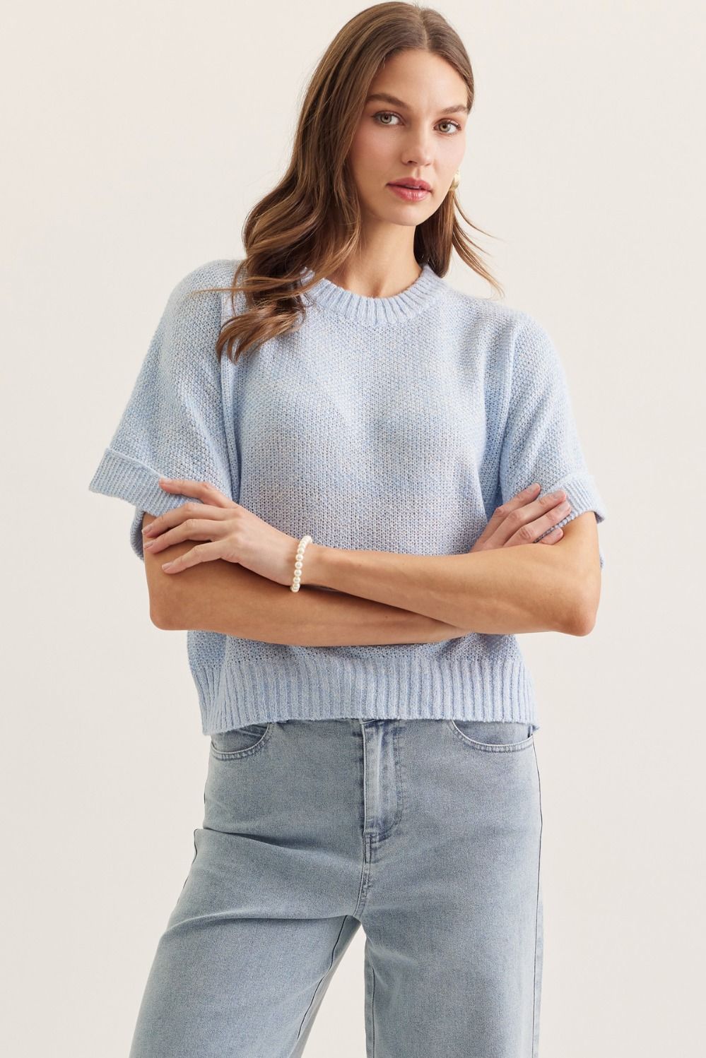 Solid short sleeve knit top featuring round neckline with rib trim