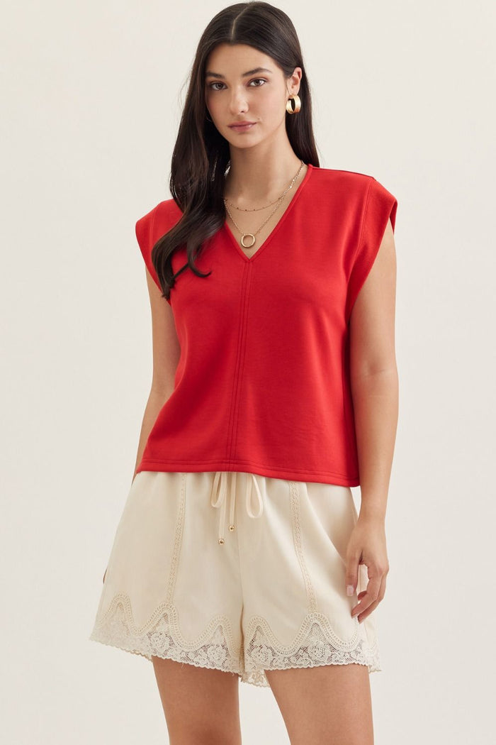 Solid cap sleeve top featuring center front seam detail