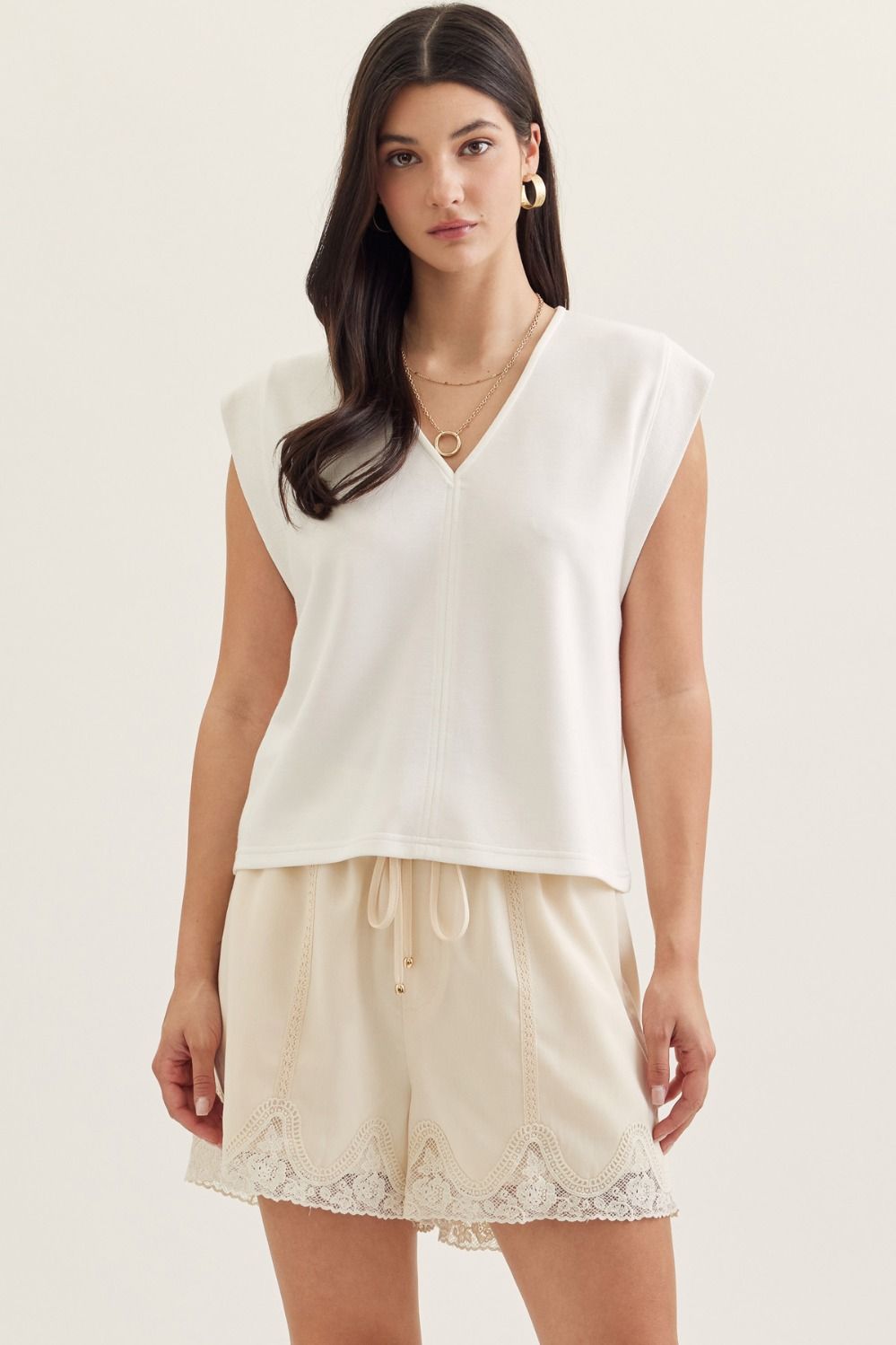 Solid cap sleeve top featuring center front seam detail