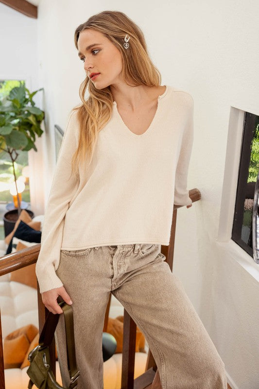 EXPOSED SEAM SPLIT NECK KNIT SWEATER