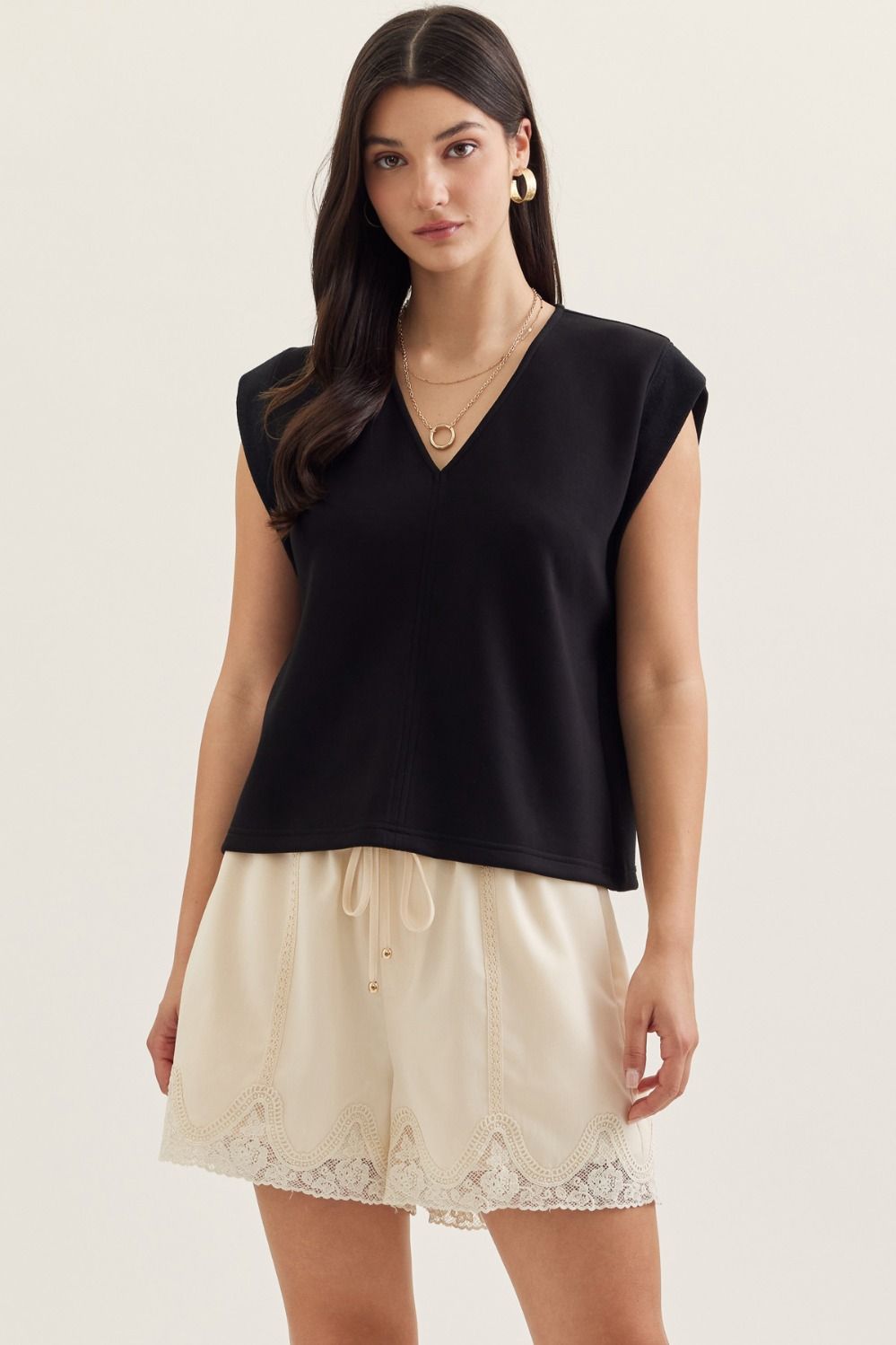 Solid cap sleeve top featuring center front seam detail