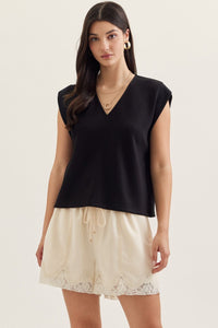 Solid cap sleeve top featuring center front seam detail