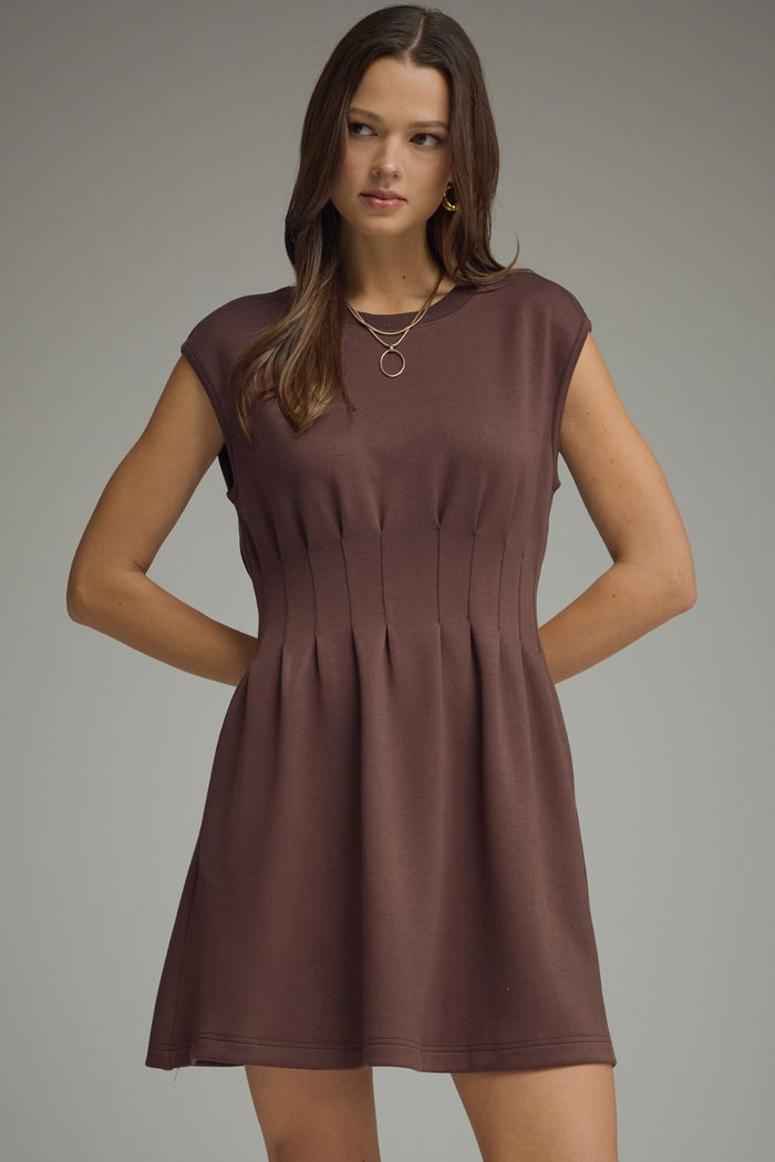 Solid cap sleeve mini dress featuring vertical pintuck detail at front bodice