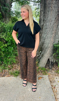 Leopard pattern pants featuring floral embroidered hem