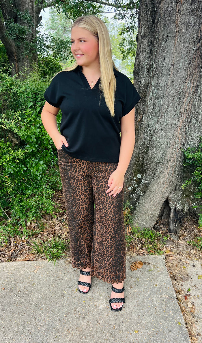 Leopard pattern pants featuring floral embroidered hem