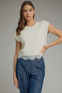 Solid cap sleeve sweater knit top featuring lace trim hem