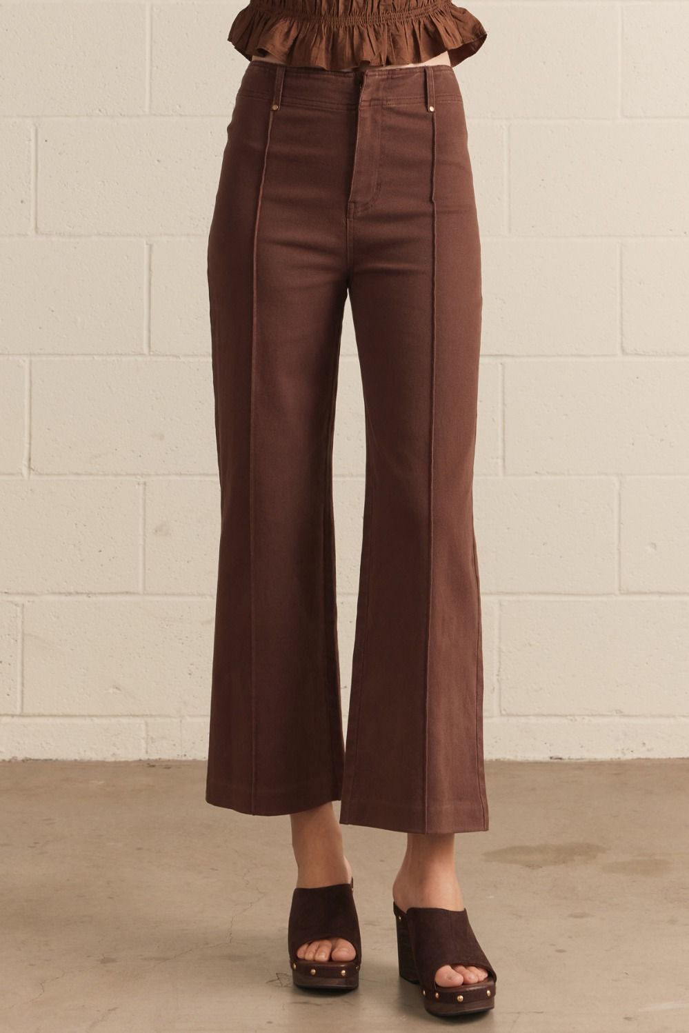 Solid high rise wide leg pants featuring front seam detail.