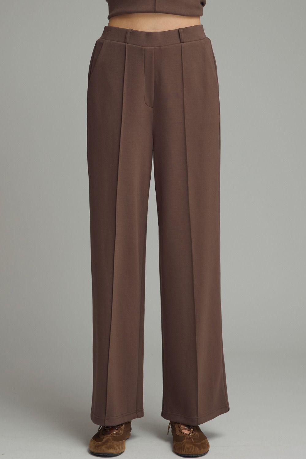 Solid knit wide leg pants featuring front center seam