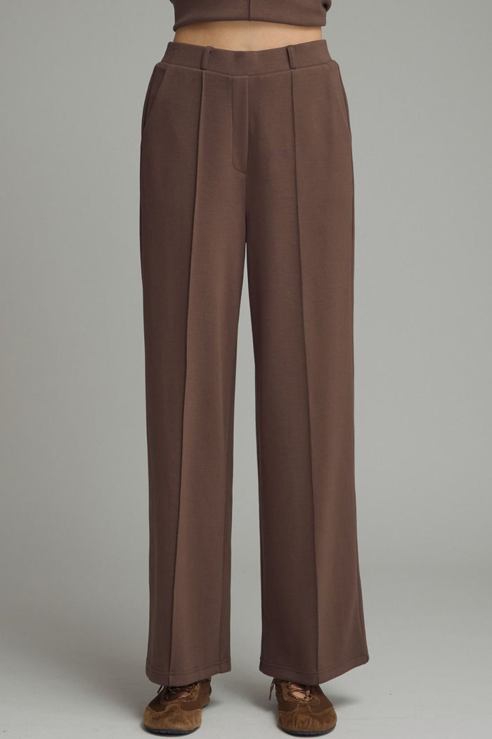 Solid knit wide leg pants featuring front center seam
