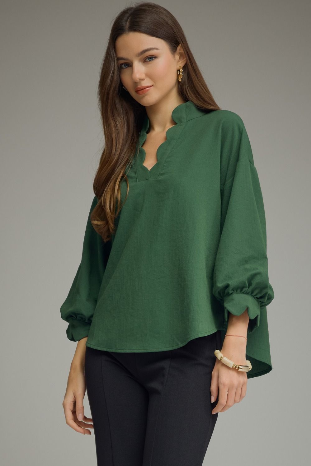 Solid long puff sleeve top featuring a scallop trim V-neck