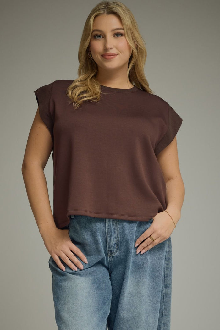 Solid round neck cap sleeve top featuring ribbed trim