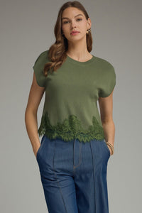 Solid cap sleeve sweater knit top featuring lace trim hem