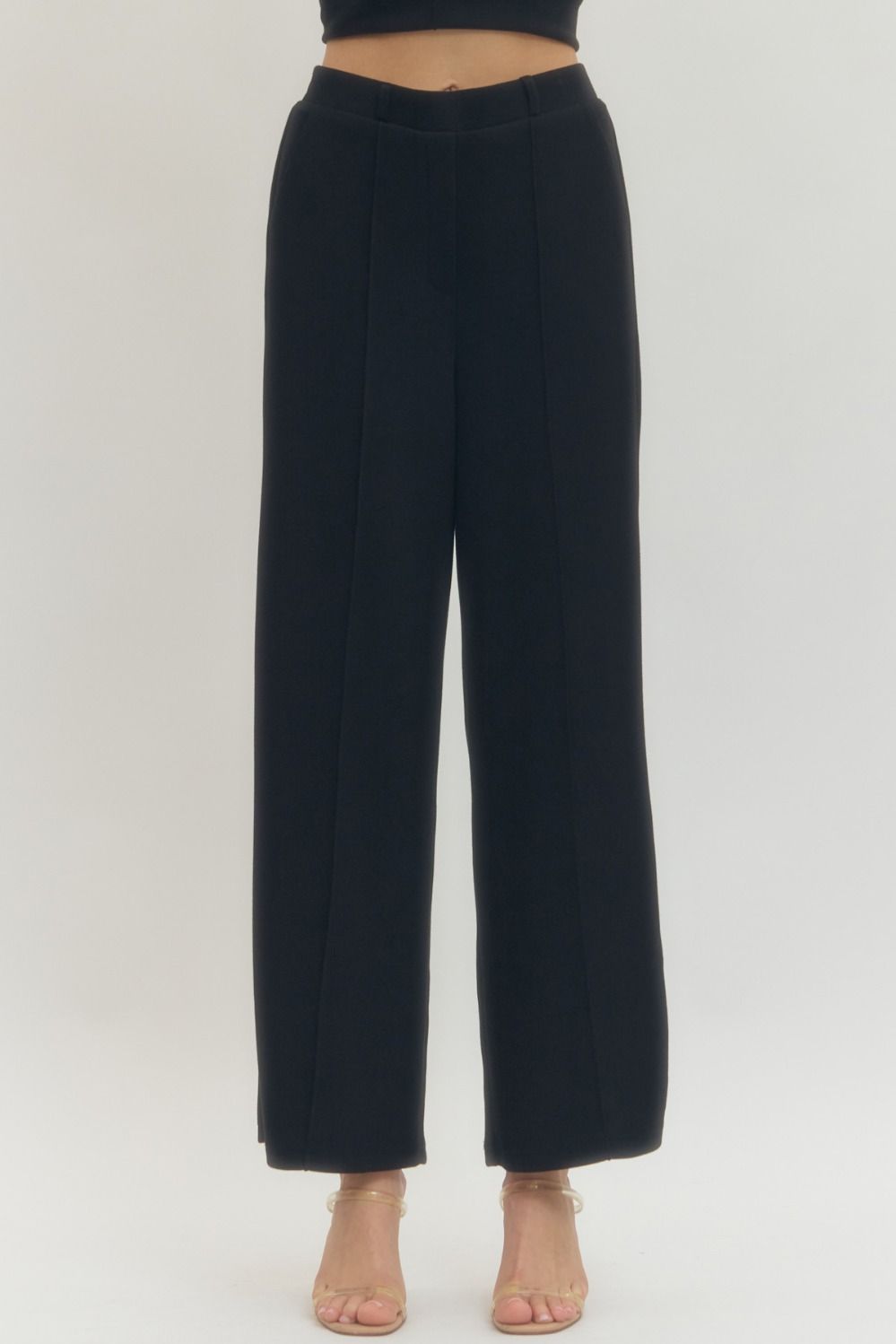 Solid knit wide leg pants featuring front center seam