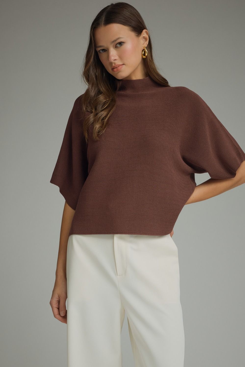 Solid mock neck short sleeve sweater knit top featuring dolman sleeves