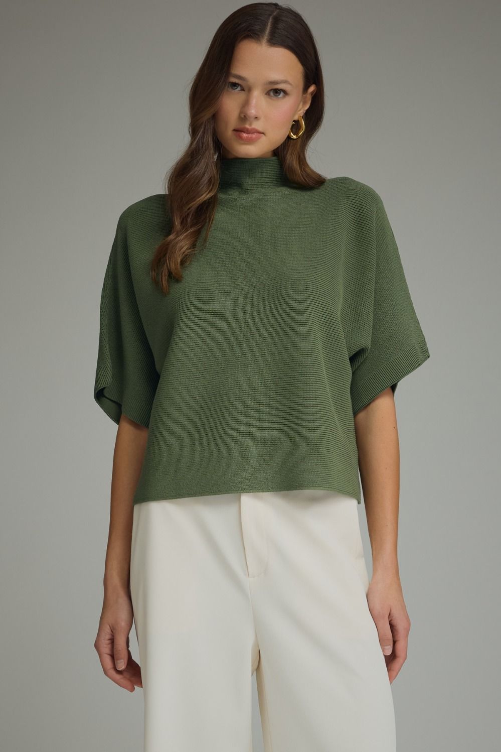Solid mock neck short sleeve sweater knit top featuring dolman sleeves