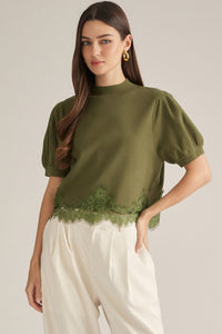 Solid short puff sleeve sweater top with a mock neck. Lace trim detail at hem.