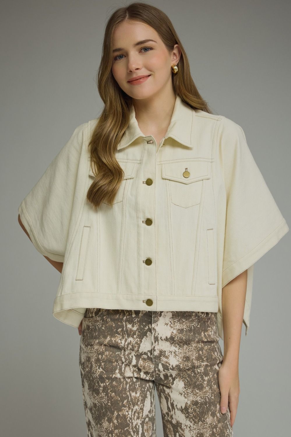 Solid denim short sleeve jacket featuring a snap button