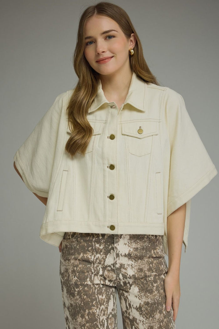 Solid denim short sleeve jacket featuring a snap button