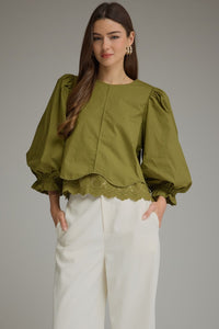 Solid ¾ balloon sleeve top with a round neckline and lace trim detail at hem