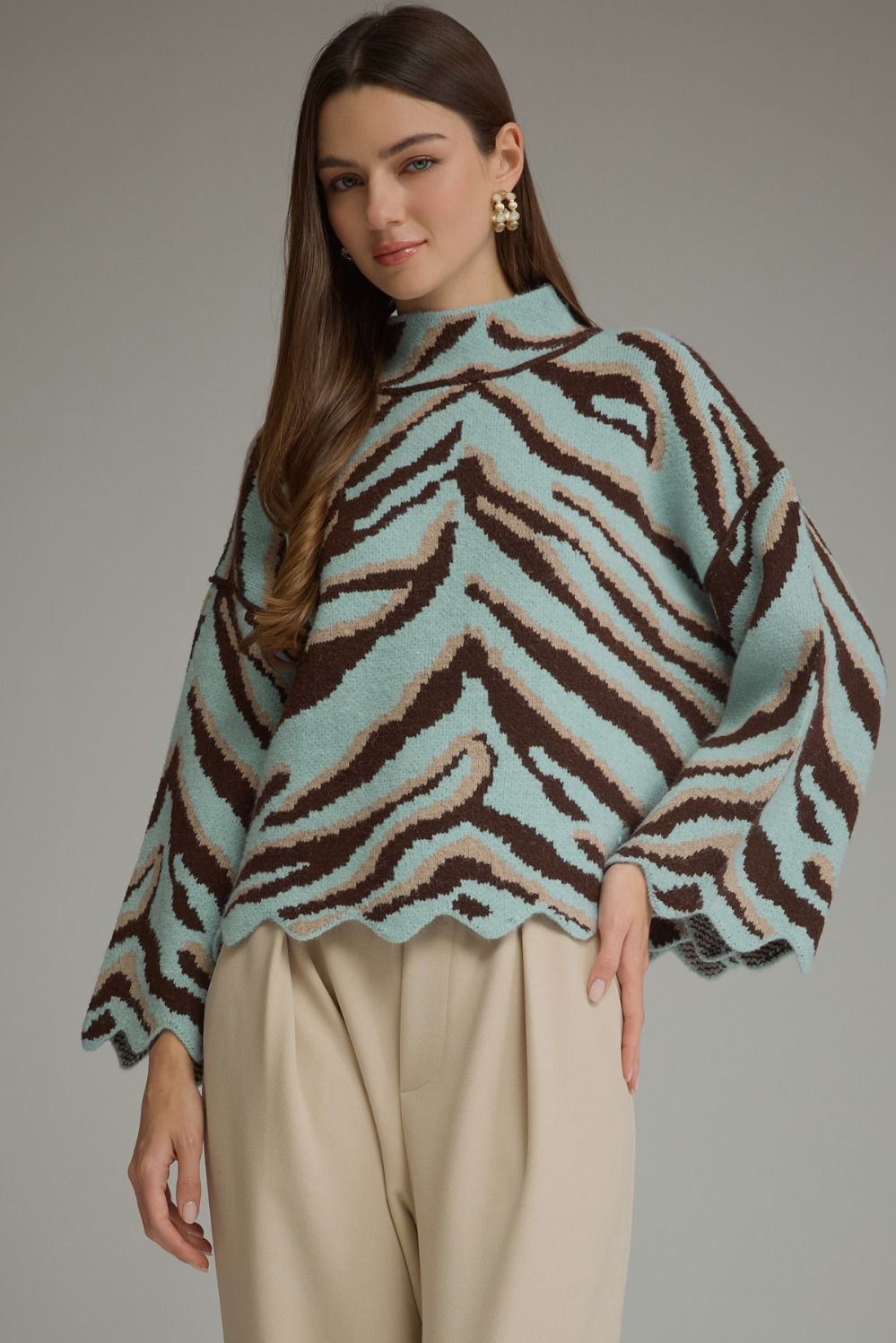 Animal print long sleeve knit top with mock neckline and scallop trim