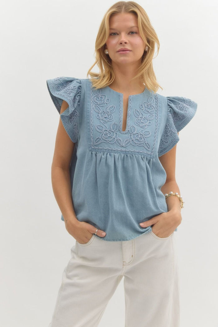 Solid split neck flutter sleeve pullover top featuring applique.