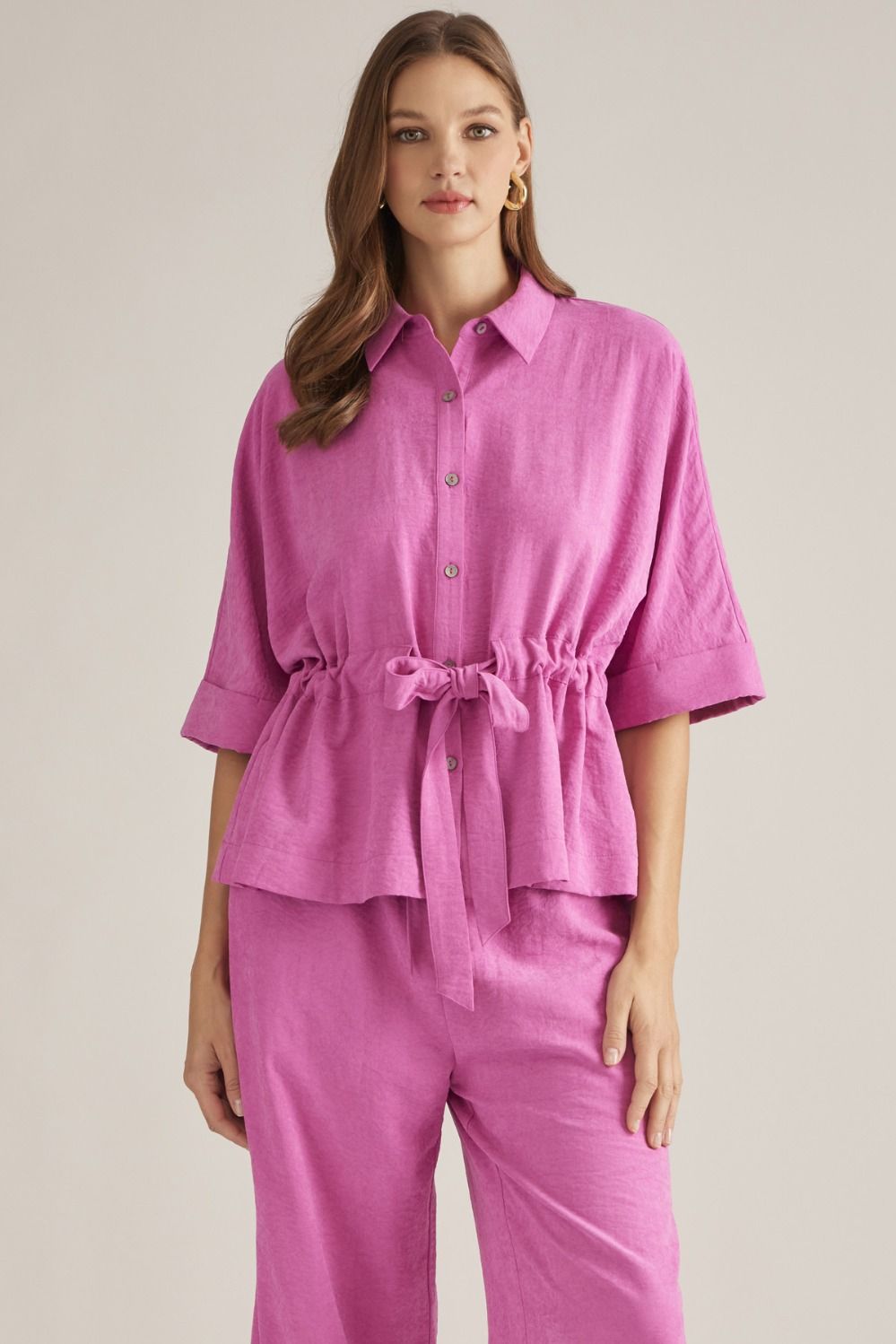 Solid 3/4 sleeve top with Self-tie detail at waist.
