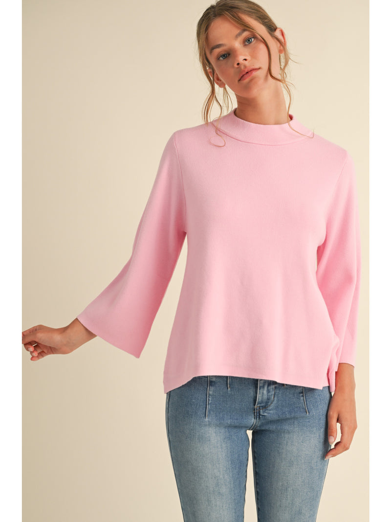 Solid knit pullover top with mock neck, and three quarter bell sleeves.