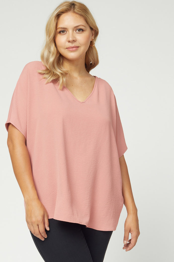 Solid v-neck top featuring asymmetric rounded hem detail. #4561P